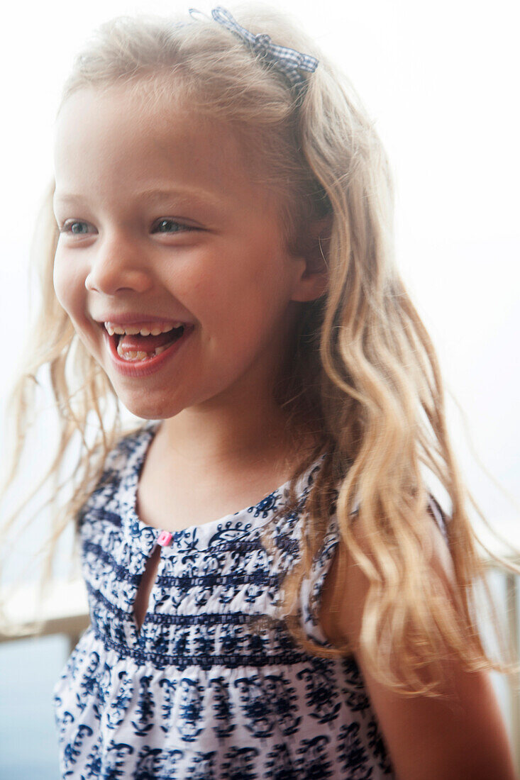 Happy girl with blonde hair looking away