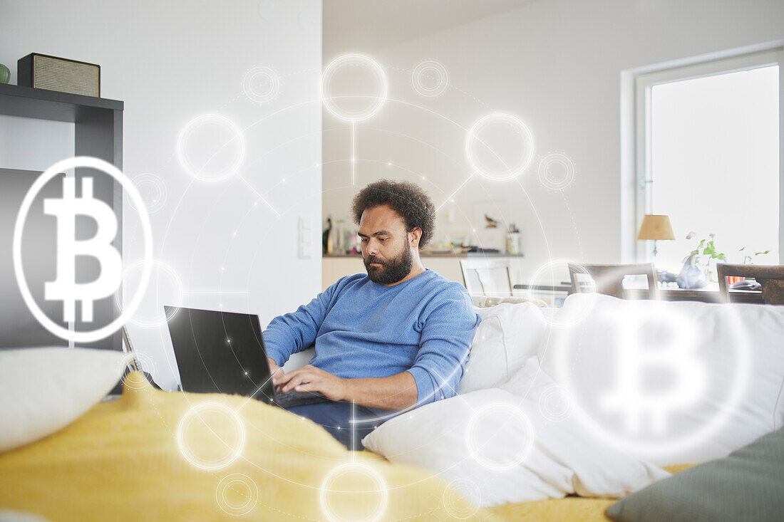 Man checking bitcoin crypto currency rates on laptop