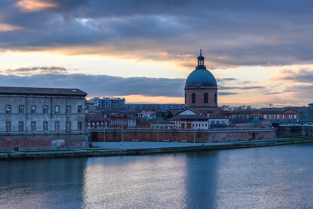 View across the Garonne river to The Hôpital de La Grave hospital, with a dome and bell tower. 