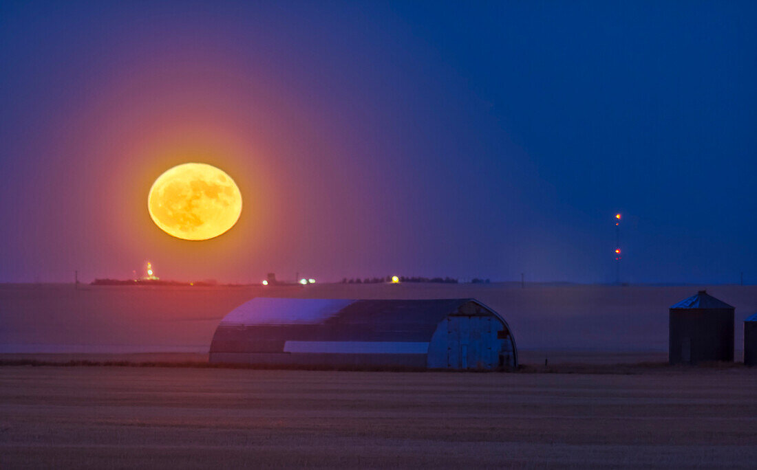 The Full Moon and a perigean Full Moon at that, rising near home over a prairie farm in the distance, on December 3, 2017.