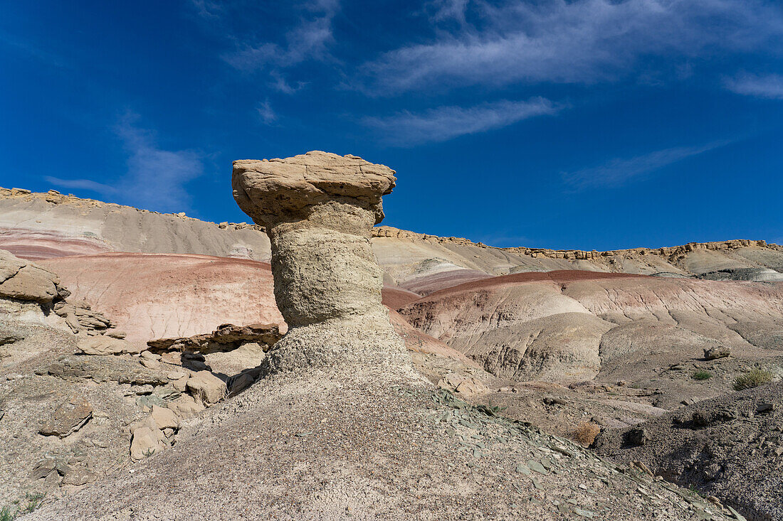 Eine Sandsteinkuppe auf einem Lehm-Hoodoo in den Bentonit-Hügeln der Caineville-Wüste bei Hanksville, Utah.
