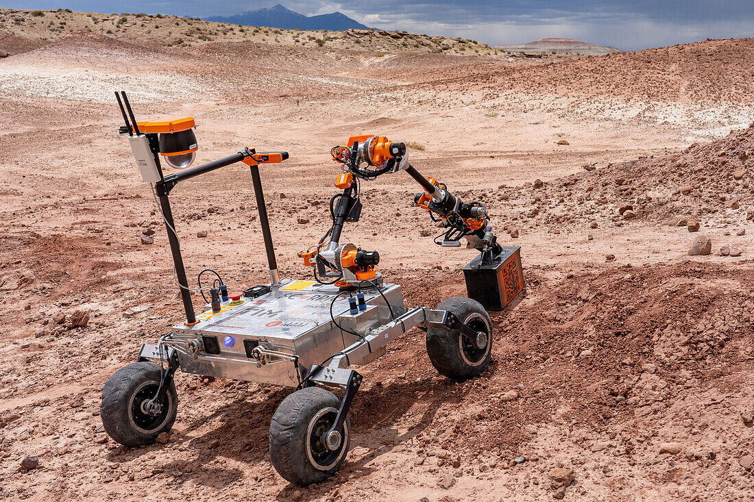 Mars Rover of the Project Scorpio Team picks up a toolbox. University Rover Challenge, Mars Desert Research Station, Utah. Wroclaw University of Science and Technology, Poland.