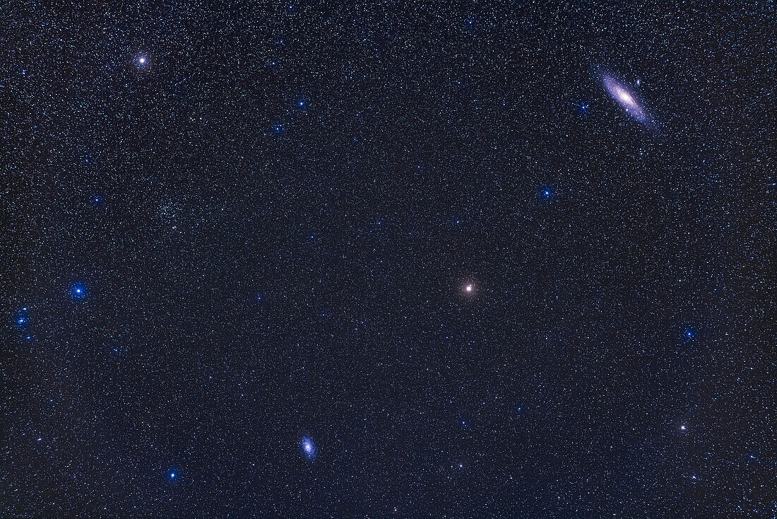 A framing of Andromeda and Triangulum showing both their respective galaxies, Messier 31 at top right, and Messier 33 at bottom left. As a bonus, the large star cluster NGC 752 is at upper left. The yellowish star that serves as a star-hopping starting point for M31 and M33, Mirach in Andromeda, is right of centre. The stars of Triangulum are at lower left. Almach in Andromeda is at upper left.