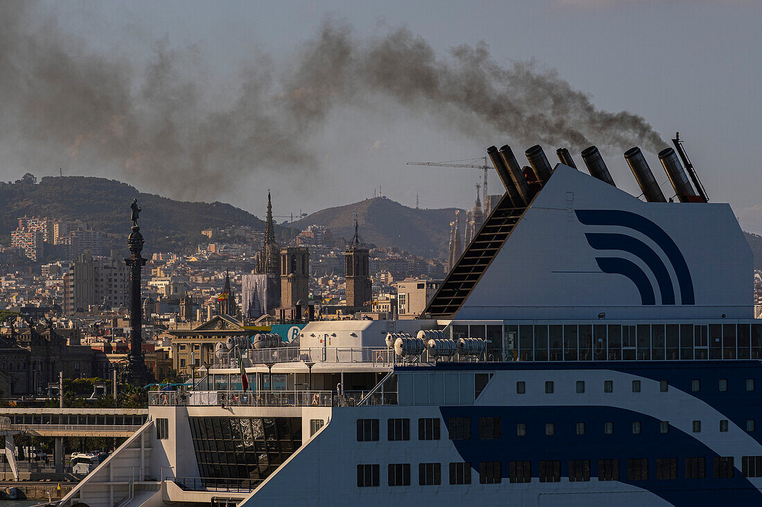 Cruise ship in the port of Barcelona expelling smoke, Barcelona, Spain