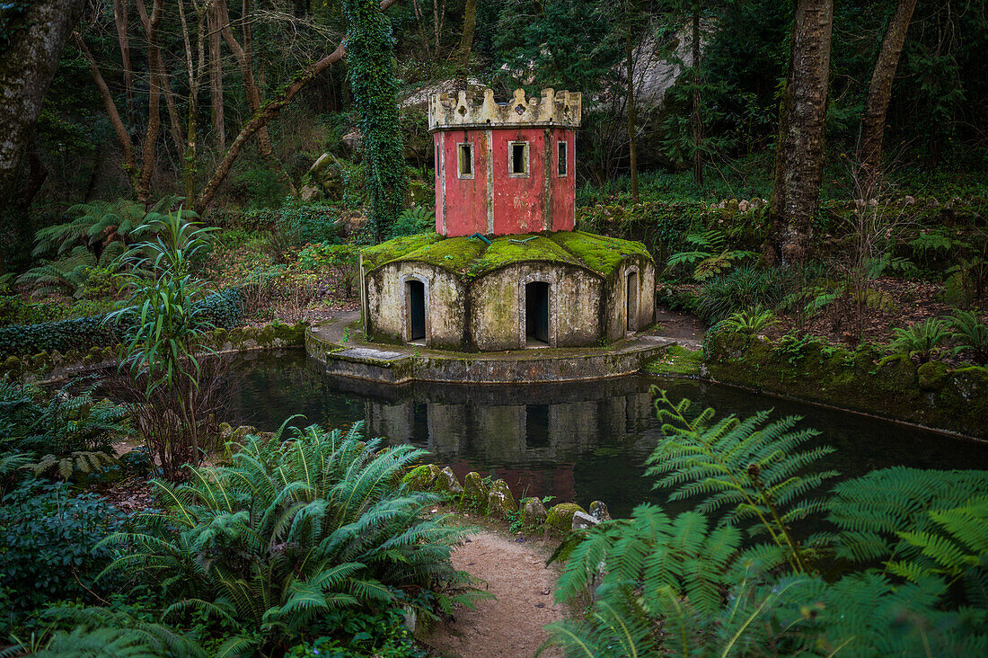 Ancient duck house resembling a tower at Valley of Lakes and Little Birds Fountain at Park and National Palace of Pena (Palacio de la Pena), Sintra, Portugal