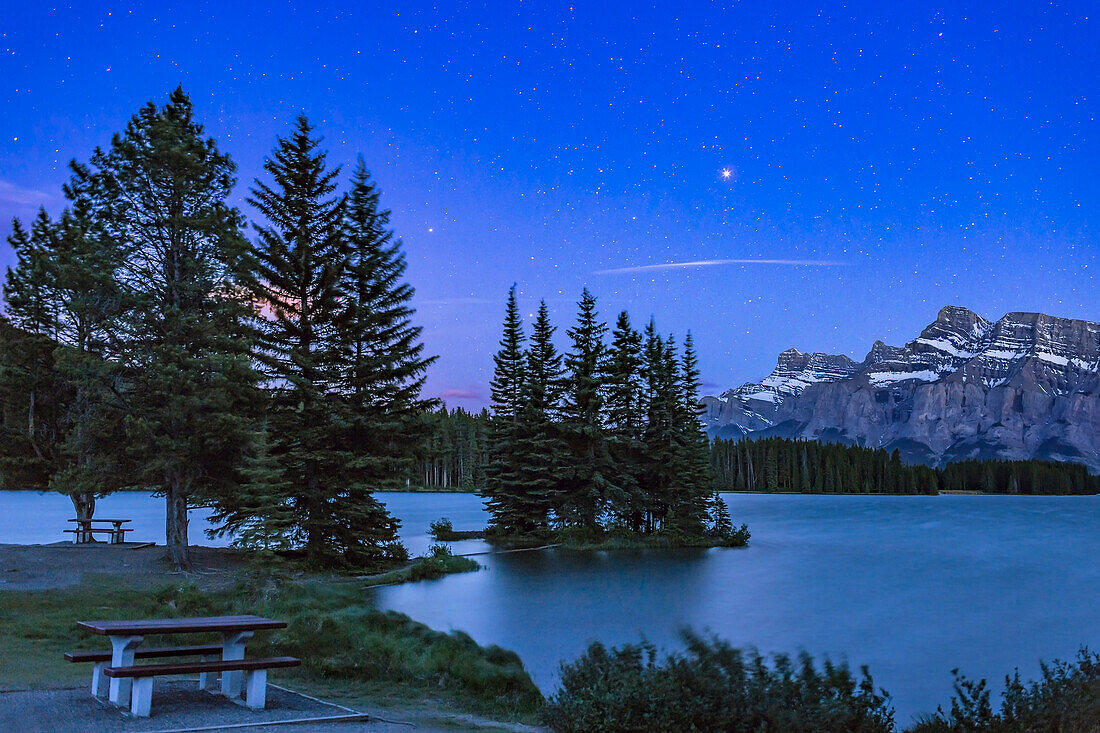 Mars (near its brightest just past closest approach) shining over Two Jack Lake and Mr. Rundle in Banff National Park. Saturn is left of Mars near the trees, Antares below in the trees. This was June 3, 2016. Wind prevented reflections on the water.