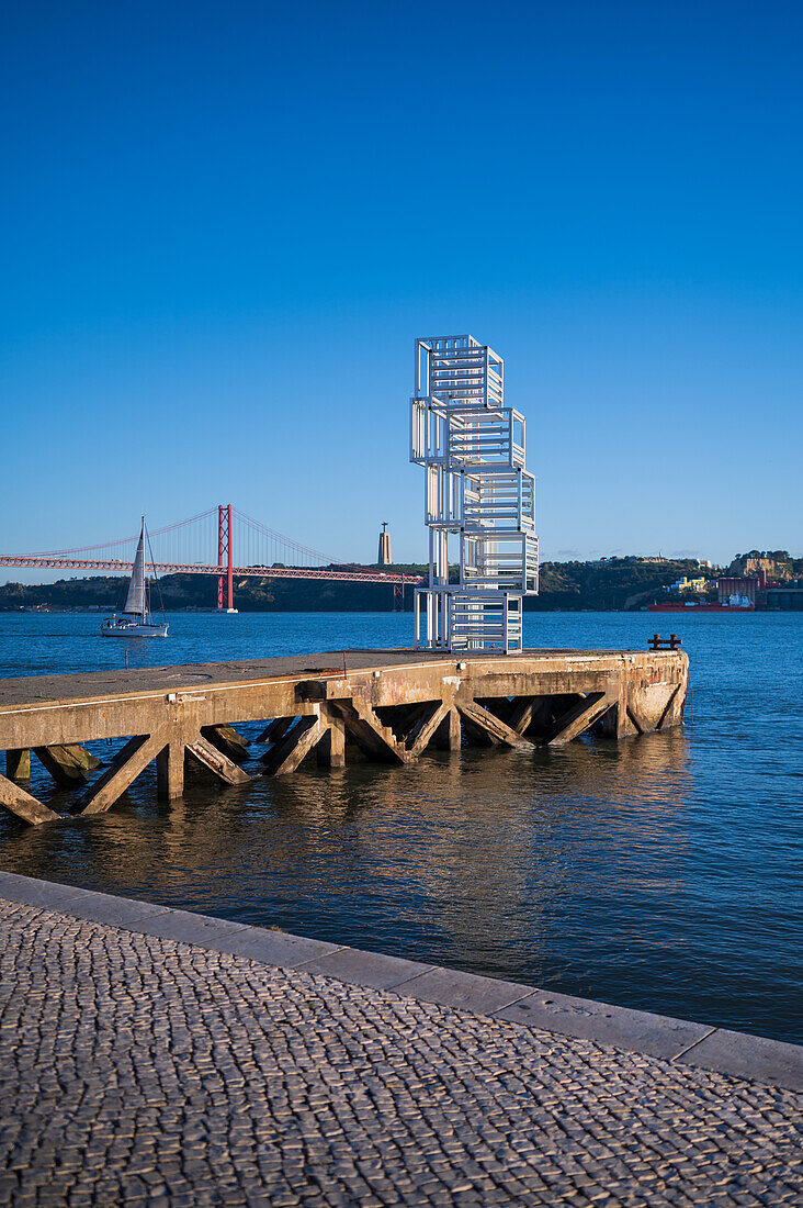 Riverside Escultura de Luz sculpture and Ponte 25 de Abril bridge by Tagus River, Belem, Lisbon, Portugal