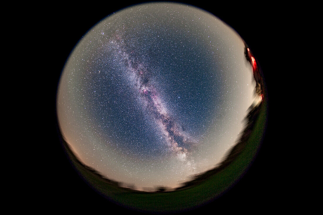 An image of the entire sky and summer Milky Way, from home in southern Alberta, from my backyard, on September 12, 2015. The night was clear but not that transparent, as some humidity and haze added more than usual horizon glows reflecting yellow light pollution. But there was no aurora, in a week filled with auroras every night. The prominent red nebula overhead is the North America Nebula in Cygnus. South is at bottom, west to the right.