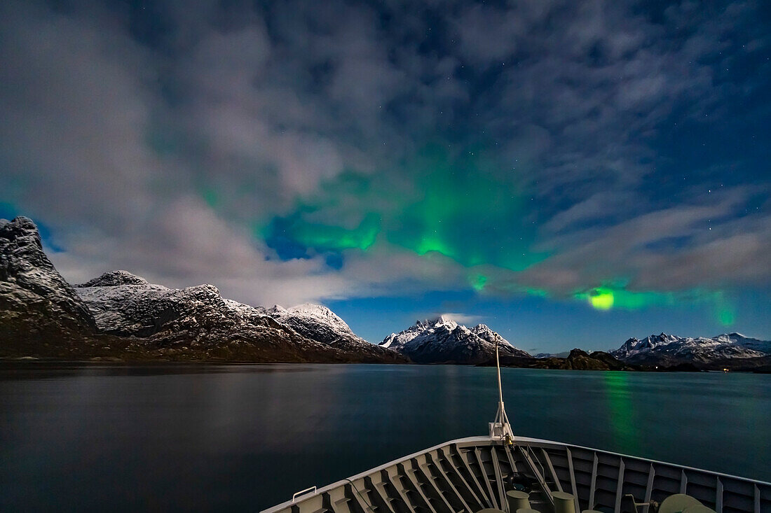 The Northern Lights in the moonlight arcing over the Rafsundet Strait near the entrance to the Trollfjord in Norway. This was from the deck of the ms Trollfjord, October 15, 2019 on the northbound cruise.