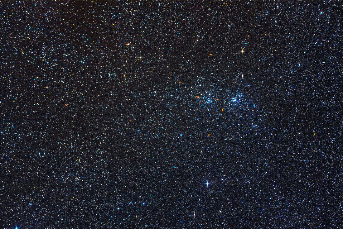 The well-known Double Cluster (aka NGC 884 and NGC 869) framed at upper right to include two of its companion star clusters, NGC 957 at upper left and Trumpler 2 at lower left. Dotted through the field of young blue stars are numerous aging yellow giant stars. And the gradation in sky colour from the clearer, bluer sky with more stars at right to the dustier, yellower sky and fewer stars at left is subtle but obvious here, from interstellar dust in this part of the Milky Way.