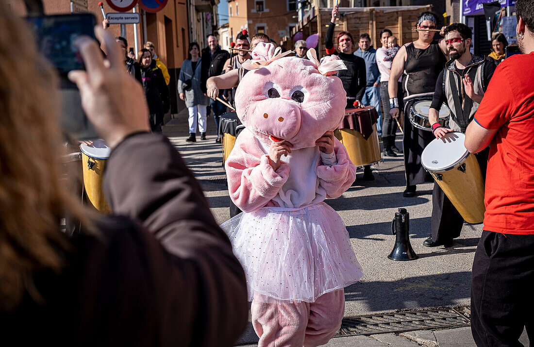 Mascot dancing to the rhythm of the batucada. Firaporc, pig fair, Riudellots de la Selva, Catalonia, Spain