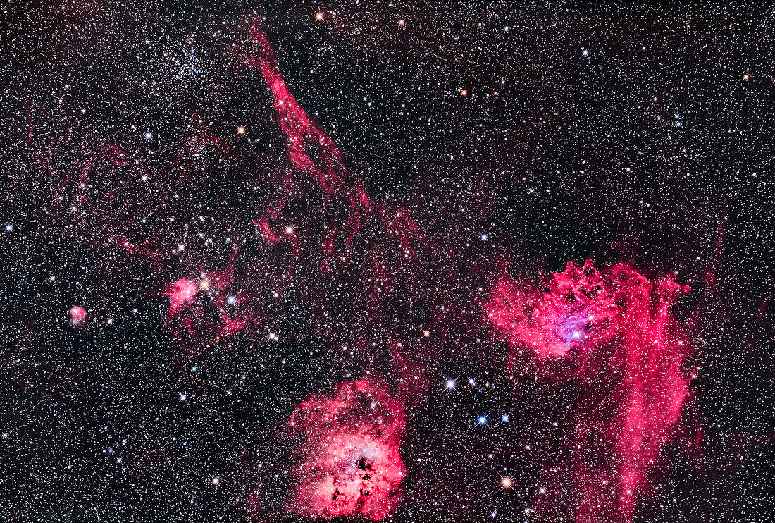 This is the rich region in the centre of the constellation of Auriga with the Flaming Star Nebula, IC 405 at right, and the roundish IC 410 at bottom with the cluster NGC 1893. At top left is the star cluster Messier 38, with small NGC 1907 below it. The small nebula at left is IC 417 around the loose cluster Stock 8. The large elongated nebula at top is Sharpless 2-230. The colourful asterism of stars between IC 405 and IC 410 is the Leaping Minnow or Little Fish, aka Mel 31.