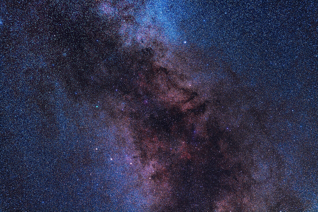 A framing of the Milky Way in Sagitta and Vulpecula below Cygnus. The stars of Sagitta the Arrow are at lower left. The distinctive asterism, the Coathanger, is at lower right embedded in the dark lanes of the Milky Way. It is also called Collinder 399 and Brocchi's Cluster. The green Dumbbell Nebula, M27, is just left of centre. The star Albireo is at top. Faint nebulosity inhabits the area, such as NGC 6820 left of the Coathanger, but as this was shot with an unmodified camera the red nebulas don't show up well here.