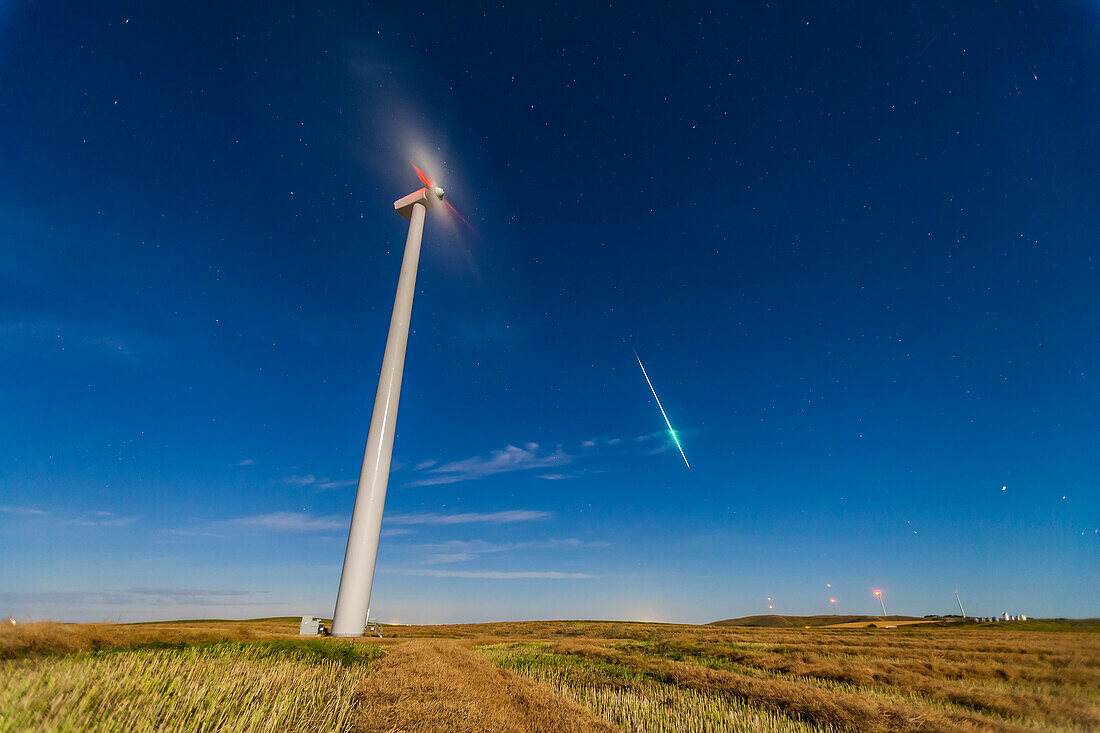 A single frame from a 300-frame time lapse movie, this one showing a bright meteor that showed up only on that one frame, a bit of luck as each exposure was only 4 seconds at 4 second intervals. Taken with the Canon 5D MkII and 16-35mm lens at f/2.8 and ISO 1600 to keep exposures short to minimize blurring of the windmill blades (to no avail), despite the bright moonlight from a Full Moon.