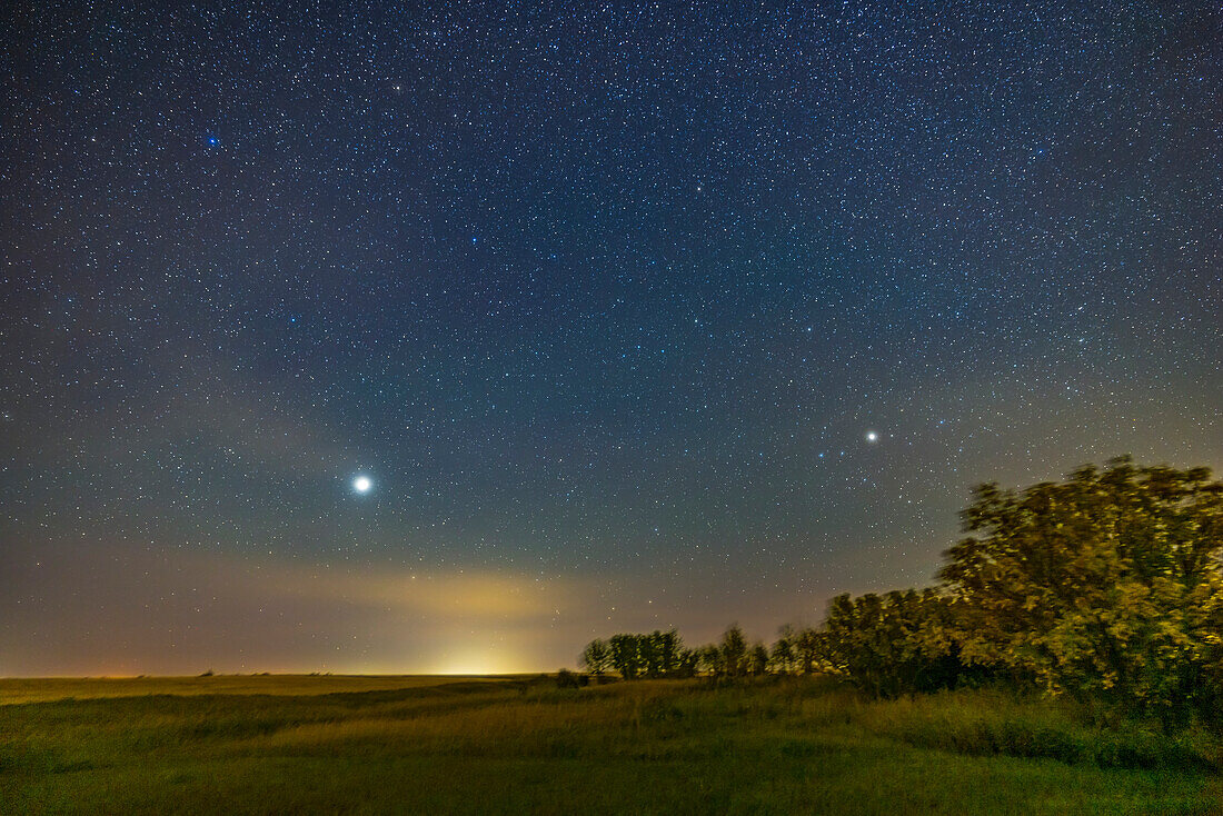 Jupiter (bright at left in Pisces) and Saturn (dimmer at right in Capricornus) low in the southeast sky on a mid-September evening in 2022. Jupiter was then nearing its opposition, and a close one at that in 2022, appearing brighter than it usually does at opposition. Jupiter appears below the Square of Pegasus at upper left. This was from home in southern Alberta at latitude 51° N.