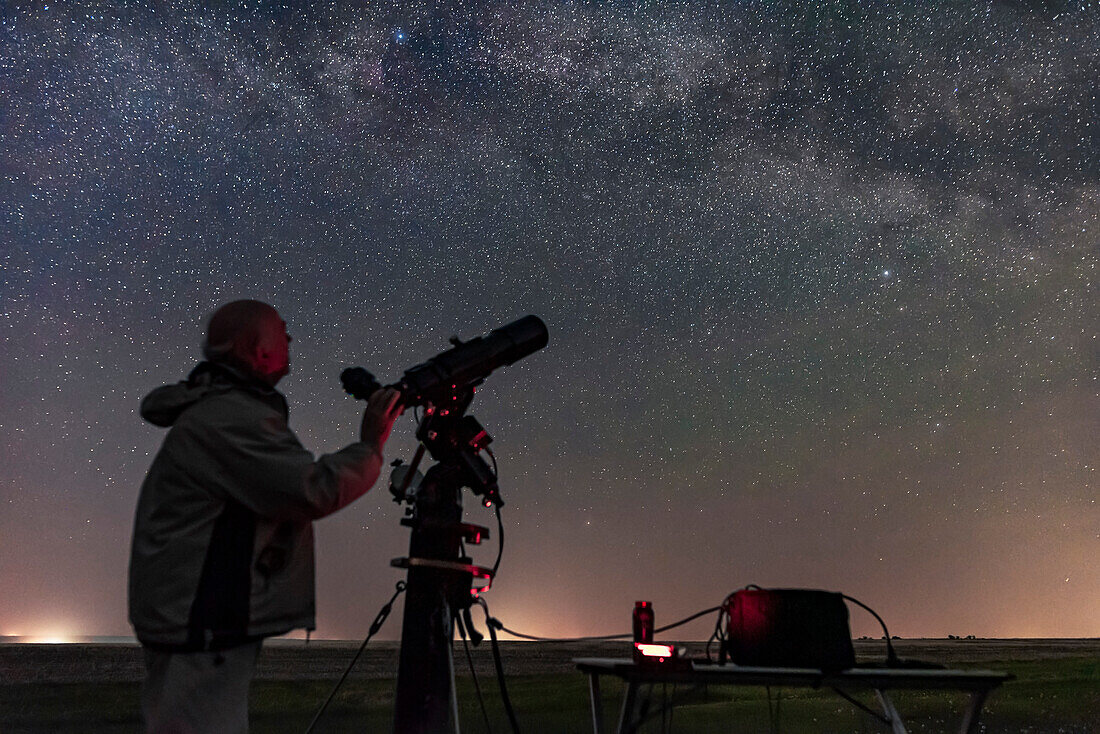 A selfie of me using the Astro-Physics Traveler 105mm apo scope on a night of visual observing logging comments on deep-sky objects for ebook use. The night was hazy and smoky and had more horizon sky glows than usual.