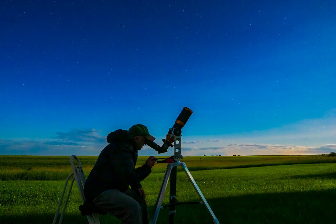 A selfie of me observing in the moonlight with the 80mm apo refractor. For use as a book illustration.