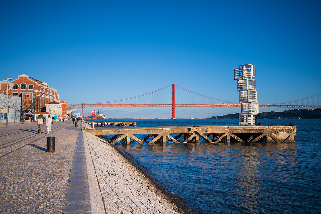 Riverside Escultura de Luz sculpture and Ponte 25 de Abril bridge by Tagus River, Belem, Lisbon, Portugal