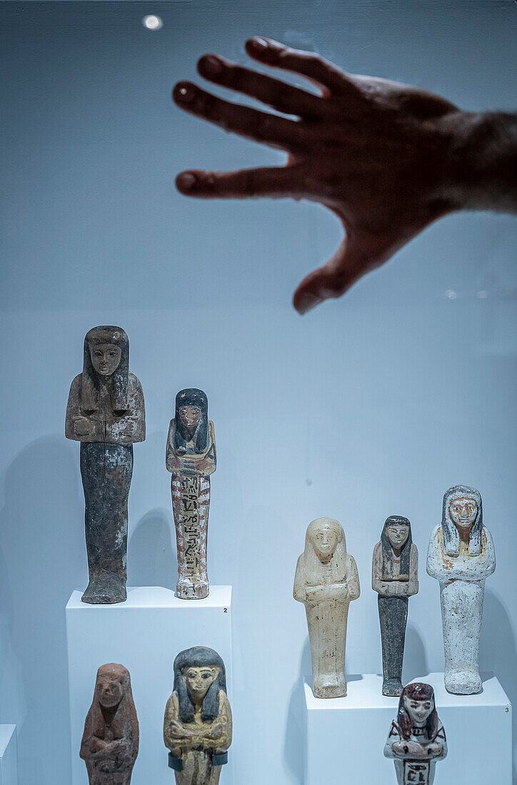 Climate activists stick their hands with glue to the showcases and pour liquids simulating blood and oil on the showcases of the Egyptian Museum of Barcelona, Spain