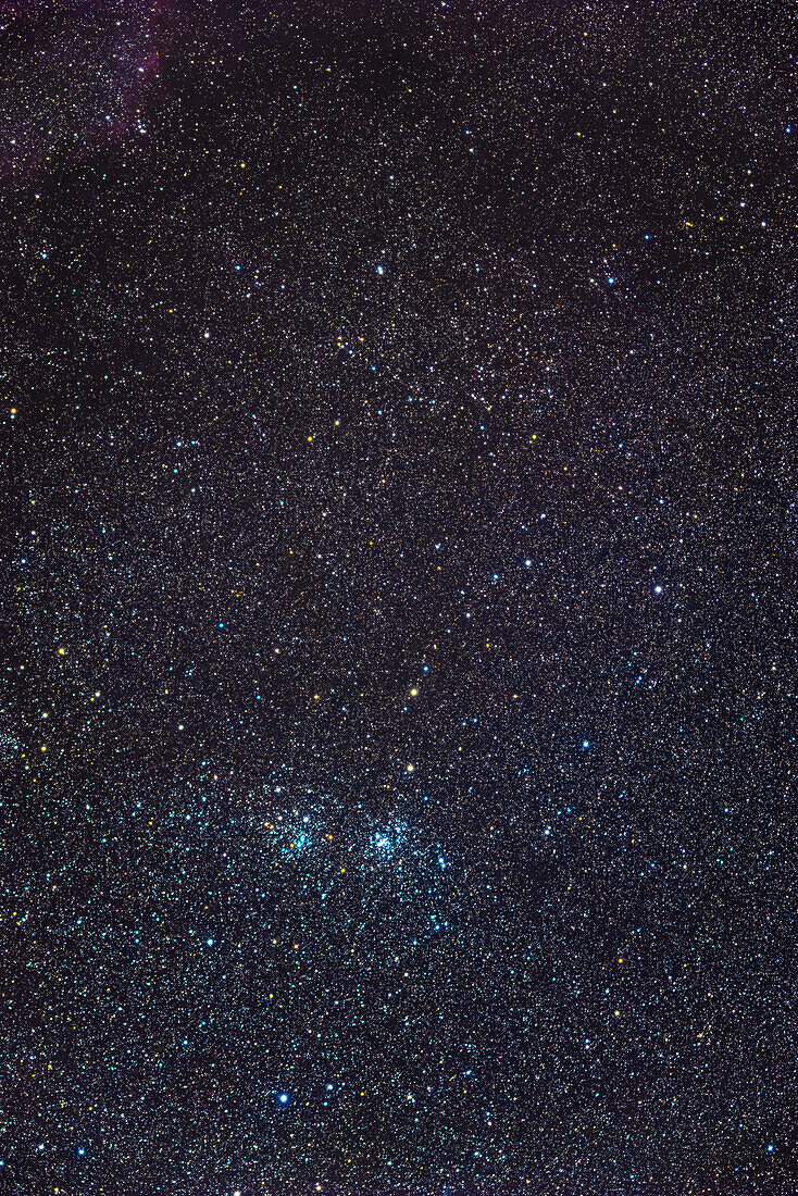The famous Double Cluster (NGC 869, right and NGC 884, left) in Perseus, in a wide-field shot that incl;udes the large and sparse cluster Stock 2, aka the Muscle Man Cluster, is at top, looking here as if it outlined by a square border of stars. The field is filled with yellow supergiant stars.