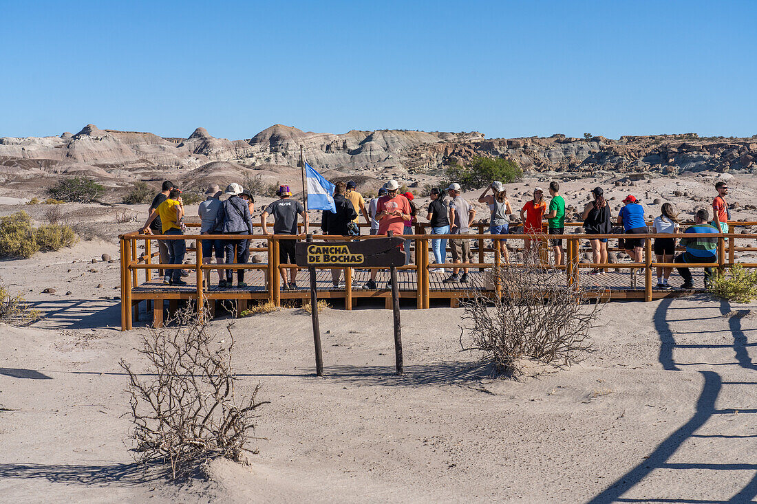 Tourists on the boardwalk in the barren landscape in Ischigualasto Provincial Park, San Juan Province, Argentina.