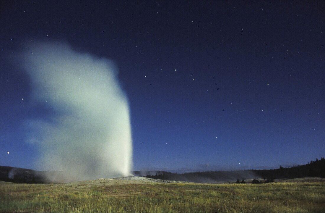 Big Dipper stars and Old Faithful geyser, Yellowstone National Park, Wyoming.