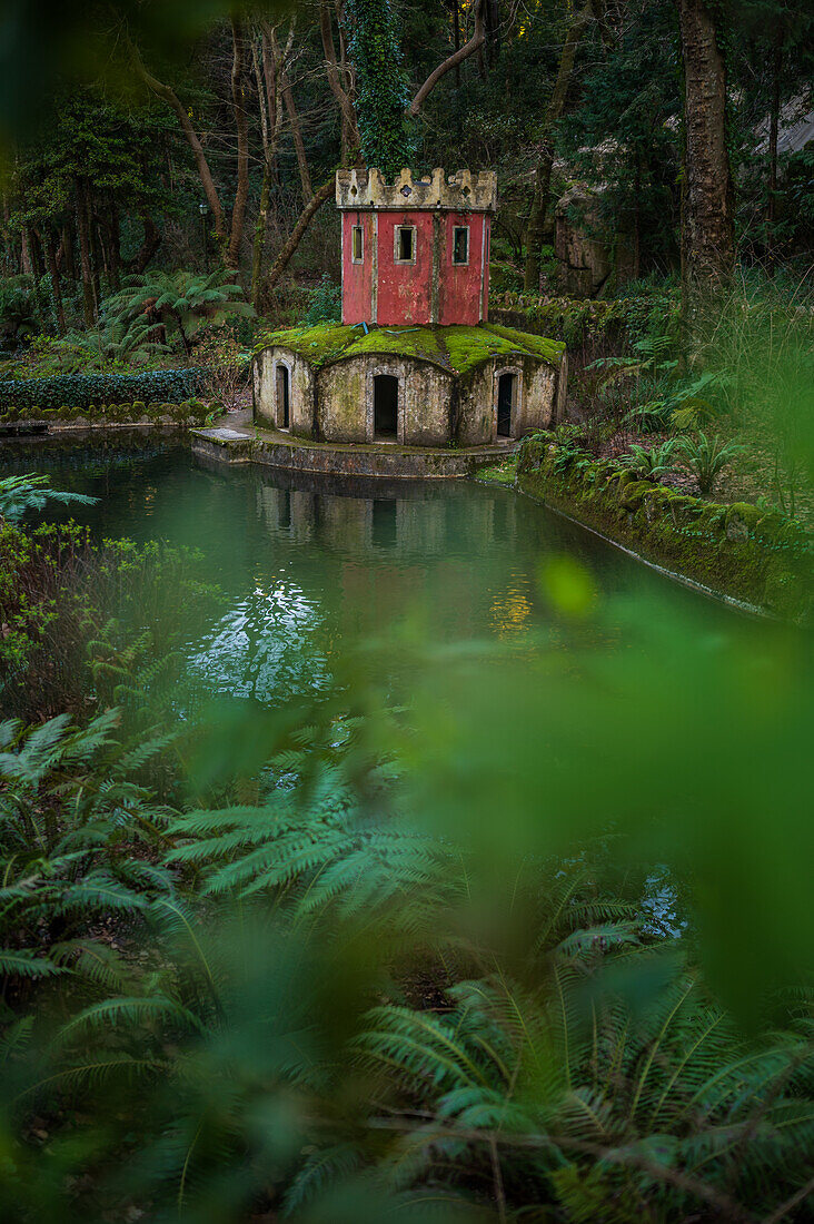 Ancient duck house resembling a tower at Valley of Lakes and Little Birds Fountain at Park and National Palace of Pena (Palacio de la Pena), Sintra, Portugal