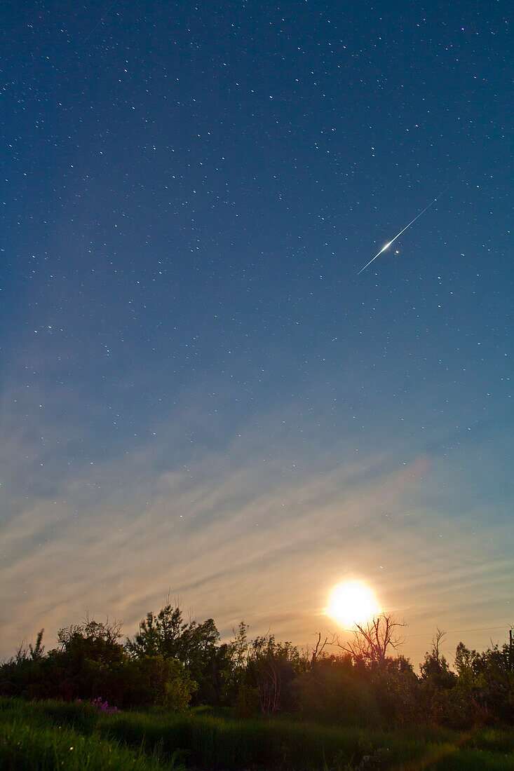 Bright -6 magnitude Iridium flare, June 21, 2010, at 12:28 am MDT, moving from south to north. Camera on tripod exposure for 40s at f/4 with 24mm lens, and Canon 5D MkII camera at ISO 1000. Star below Iridium is Acrturus.