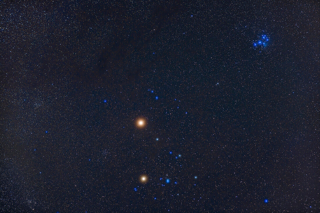 Bright reddish Mars above the Hyades star cluster with yellow Aldebaran below Mars to serve as a "compare and contrast " to Mars. The blue Pleiades are at upper right. Two other NGC clusters in Taurus are in the frame: NGC 1647 to the left of the Hyades and NGC 1747 at the right edge of the frame. The small clusters NGC 1817 and 1807 are at lower left. The Taurus Dark Clouds are at upper left. Aldebaran is magnitude +1 while Mars was -0.2 this morning and getting brighter by the day as it approached its December opposition this year, 2022.