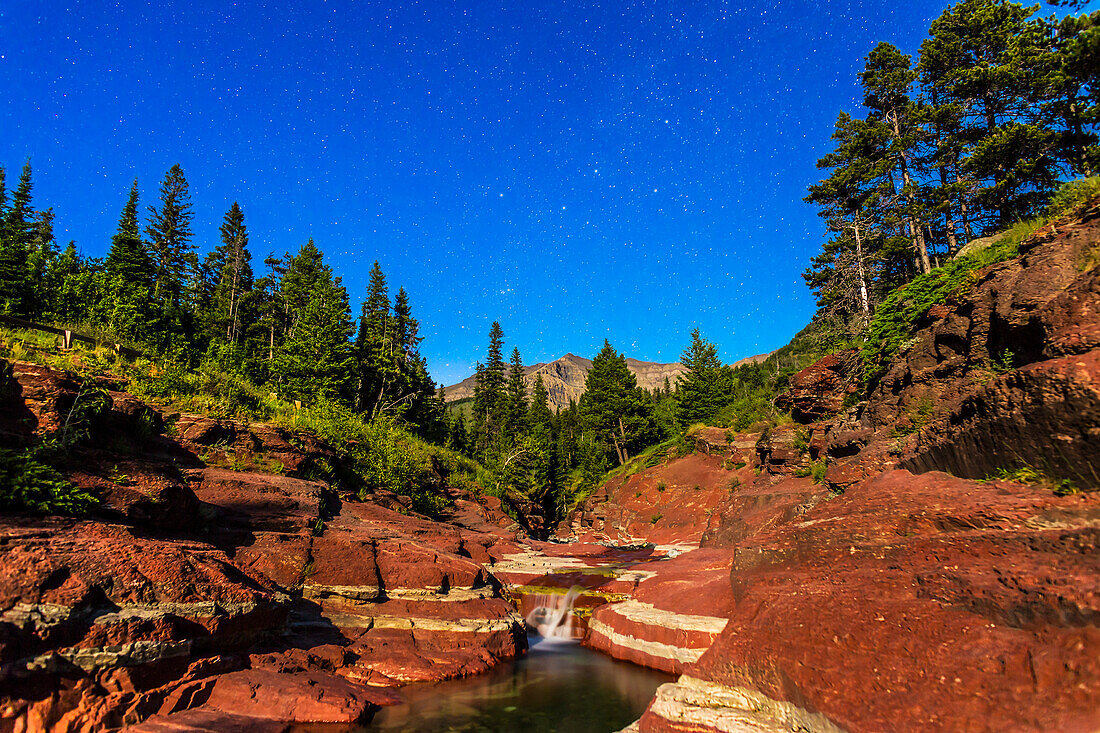 Cassiopeia and the northern stars over Red Rock Canyon in Waterton Lakes National Park, Alberta, with illumination from a waxing gibbous Moon. This is a composite of three 30-second exposures for the ground to smooth noise and one 30-second exposure for the sky, all with the 24mm lens at f/3.5 and Canon 6D at ISO 1600.