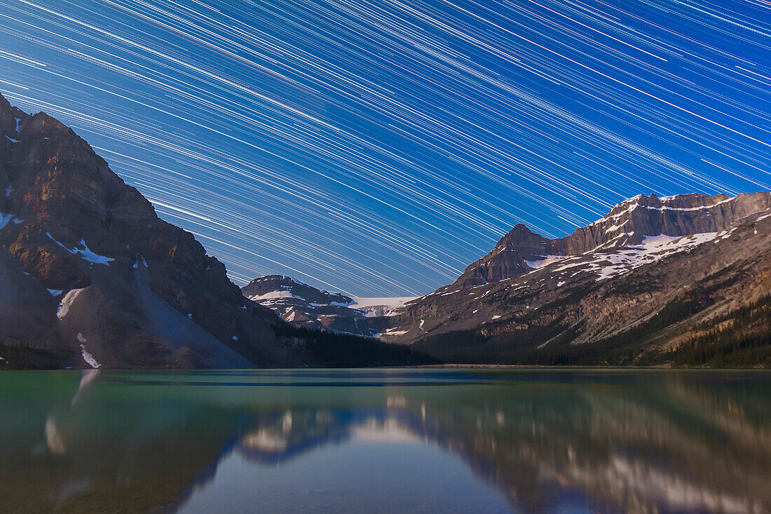 A composite of about 280 images, taken with the Canon 60Da and 10-22mm lens at 17mm, at Bow Lake in Banff, Alberta showing star trails across the sky looking west. Illumination is from the waning gibbous Moon over frame to the left Moon. Each image was 45 seconds, taken at 1s intervals at ISO 1250 and at f/4.5. Stacked in Photoshop using Chris Schur's Photoshop Action.