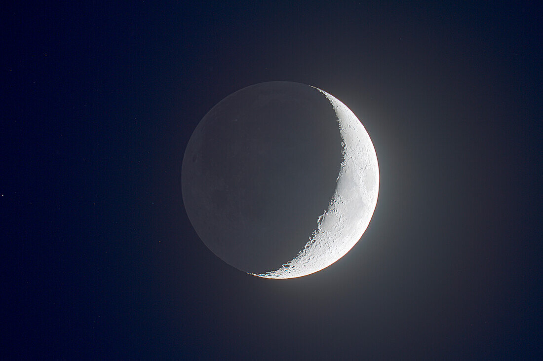 Waxing crescent Moon with Earthshine, April 18, 2010. Taken with 5-inch (130mm) Astro-Physics apo refractor and Canon 7D camera, at f/6 and ISO 100. HDR stack of 9 exposures from 6 seconds to 1/40th second at 1-stop intervals. Combined in Photomatix Pro.