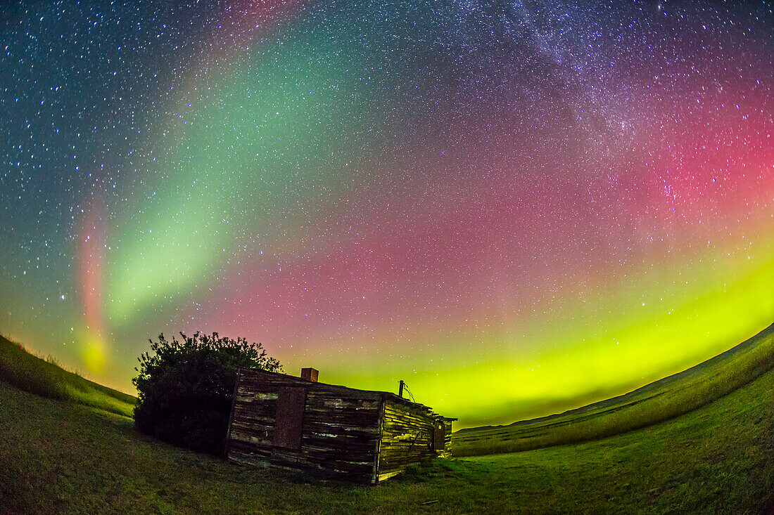 The Northern Lights shot at the old Larson Ranch site in the Frenchman Valley at Grasslands National Park, Saskatchewan, August 27/28, 2014. The pioneer cabin was the home of the legendary western author and movie star Will James, born Ernest Dufault in Quebec. He lived in this cabin when he worked the ranches in the area. The aurora was excellent this night. This is a single 1-minute exposures at ISO 2500 with the 15mm full-frame fish-eye lens at f/3.2 and the Canon 6D.