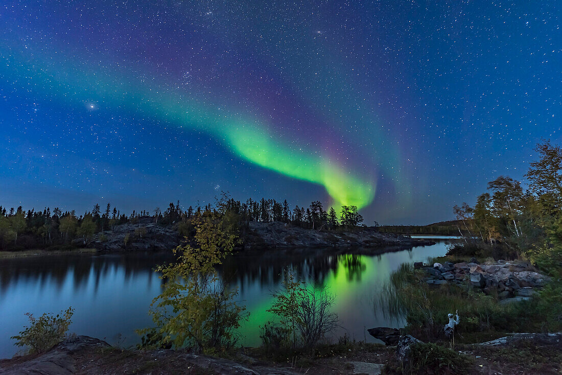 A display of Northern Lights starting up in the twilight, over the river leading out of Tibbitt Lake, at the end of the Ingraham Trail near Yellowknife NWT, on September 8, 2018. This was the start of a fabulous display this night.