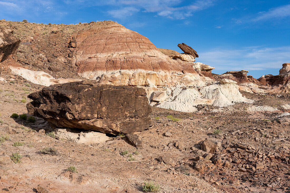 Sandstone boulders and colorful bentonite clay hills in the Caineville Desert near Hanksville, Utah.
