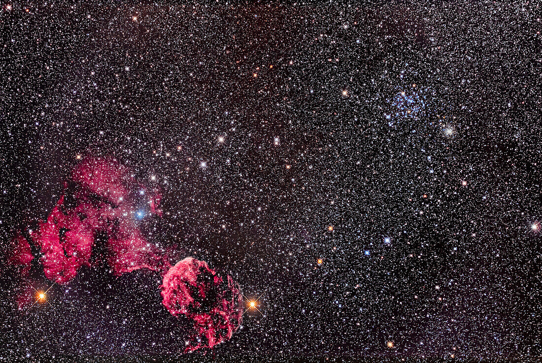 This is the rich region of clusters and nebulosity in the constellation of Gemini, with the Jellyfish Nebula, IC 443 at bottom near the orange star eta Geminorum. IC 443 is a supernova remnant. The larger region of fainter, diffuse nebulosity at left is IC 444. The loose star cluster embedded in it, with the blue star 12 Gem, is Collinder 89. At top right is the bright showpiece open star cluster Messier 35 with its smaller, more distant companion cluster NGC 2158 at lower right from M35.