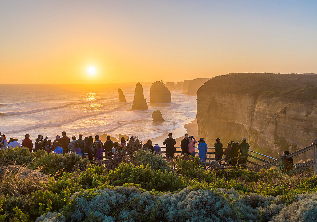 Touristen beobachten und fotografieren den Sonnenuntergang am ersten und wichtigsten Aussichtspunkt der Zwölf Apostel an der Great Ocean Road, Australien.