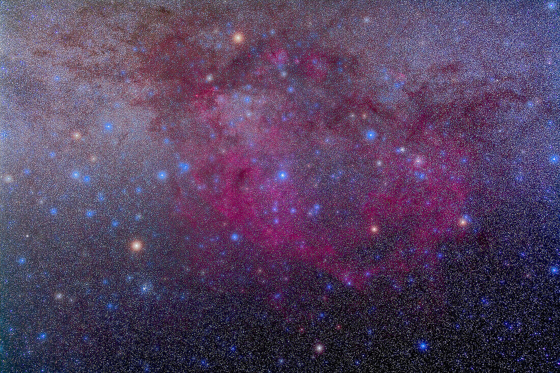 The extensive Gum Nebula area in Vela, an interstellar bubble blown by winds from hot stars, with the False Cross at left. This is a stack of 4 x 5 minute exposures at f/3.2 with the Sigma 50mm lens and filter-modified Canon 5D MkII at ISO 800. Taken from Coonabarabran, Australia, December 2012. High cloud added natural glows around stars. Star clusters NGC 2516 (below False Cross) and IC 2391 (right of false Cross) stand out. Superhot star Gamma Velorum is at centre.