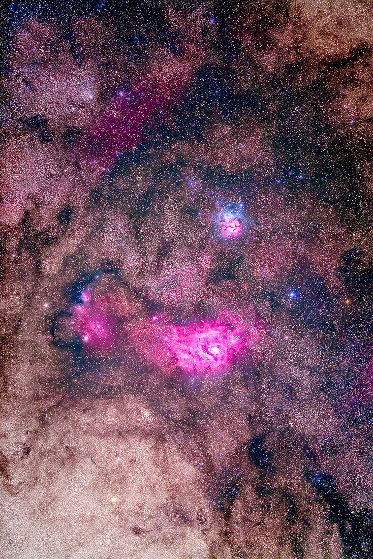 The spectacular field of Messier 8 and 20 emission and reflection nebulas in Sagittarius, with M8, aka the Lagoon Nebula below, and M20, the Trifid Nebula, above, all set in the rich starfields of the Milky Way. The diffuse nebula left of M8 is NGC 6559. Two globular clusters, NGC 6544 and NGC 6553, sit below and to the left (east) of M8. The Messier open cluster, M21, sits above M20.