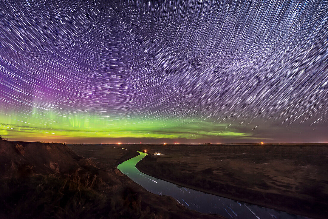 Circumpolar star trails and aurora over the Red Deer River, Alberta from the Orkney Viewpoint north of Drumheller on May 5, 2018.