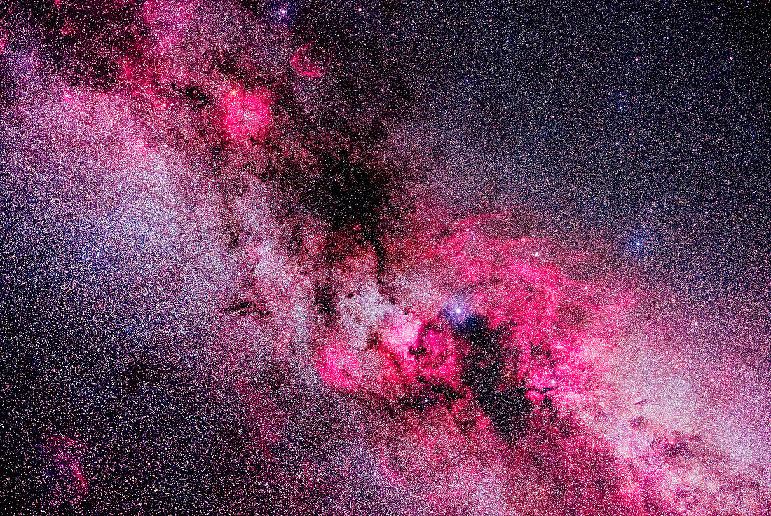 This is a framing of the rich complex of nebulosity in and around the constellations of northern Cygnus and southern Cepheus, in a blend of "white light" images and images shot through a deep red hydrogen-alpha filter that isolates the red emission line from the gas clouds, bringing them out in much more detail than is otherwise possible.