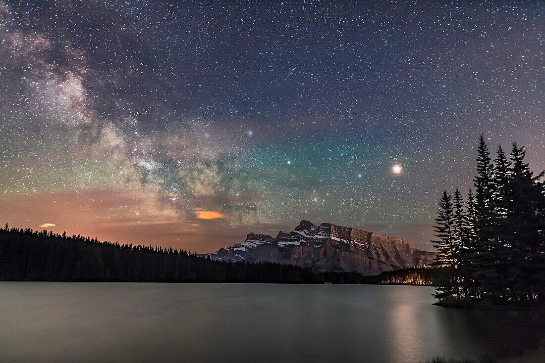 Mars, the bright object at right, with Saturn to the left and Antares below Saturn, in Scorpius, all above Mt. Rundle, with the Milky Way at left. The area of the galactic centre in Sagittarius is just above the horizon.