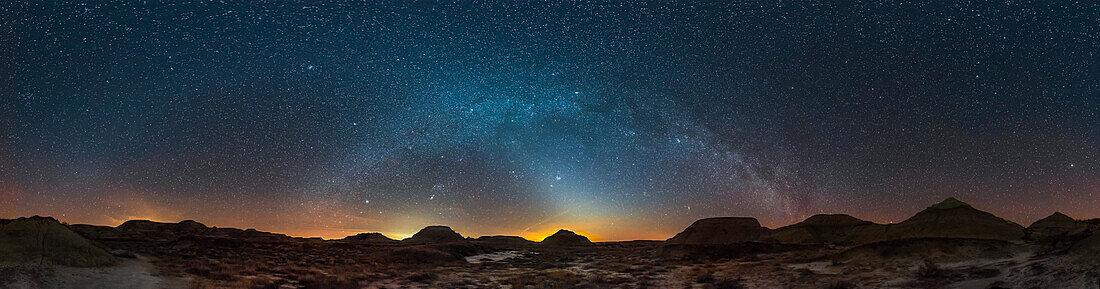 A 360° panorama of the spring sky over the Badlands of Dinosaur Provincial Park, Alberta, on March 29, 2019, with the winter Milky Way and constellations setting at centre, and the spring constellations filling the sky at left and right. At centre is also the tapering pyramid-shaped glow of the Zodiacal Light, which continues to the left across the sky as the Zodiacal Band and brightening at far right above the horizon as the Gegenschein. Urban sky glows from Brooks and Calgary mar the horizon with white and yellow glows. Mars is just below the Pleiades at centre in the Zodiacal Light.