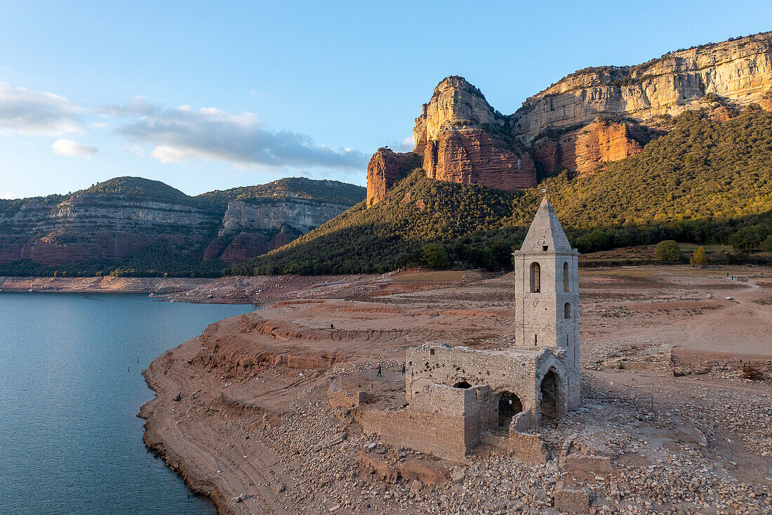 Sau reservoir and Sant Romà de Sau church during a drought, Osona, Barcelona, Spain