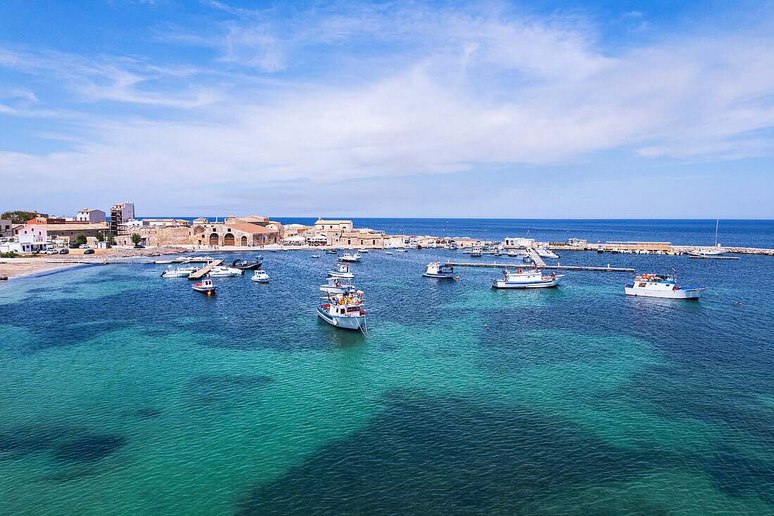 Aerial view of the harbour of the fishing village of Marzamemi with fishing boats floating in turquoise waters, Marzamemi, Pachino municipality, Siracusa province, Sicily,  Italy, Mediterranean, Europe