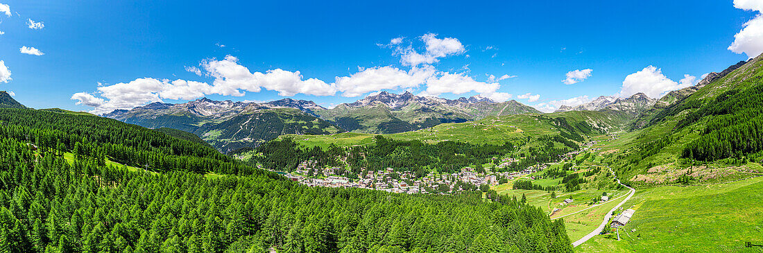 Aerial panoramic of the alpine village of Madesimo surrounded by green woods, Valle Spluga, Valtellina, Lombardy, Italy, Europe