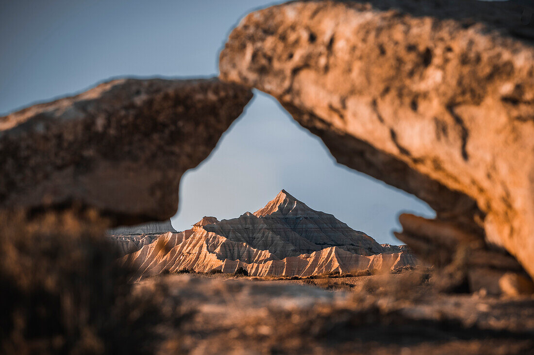 Badlands of Bardenas Reales mountains framed by two rocks, Navarre, Spain, Europe