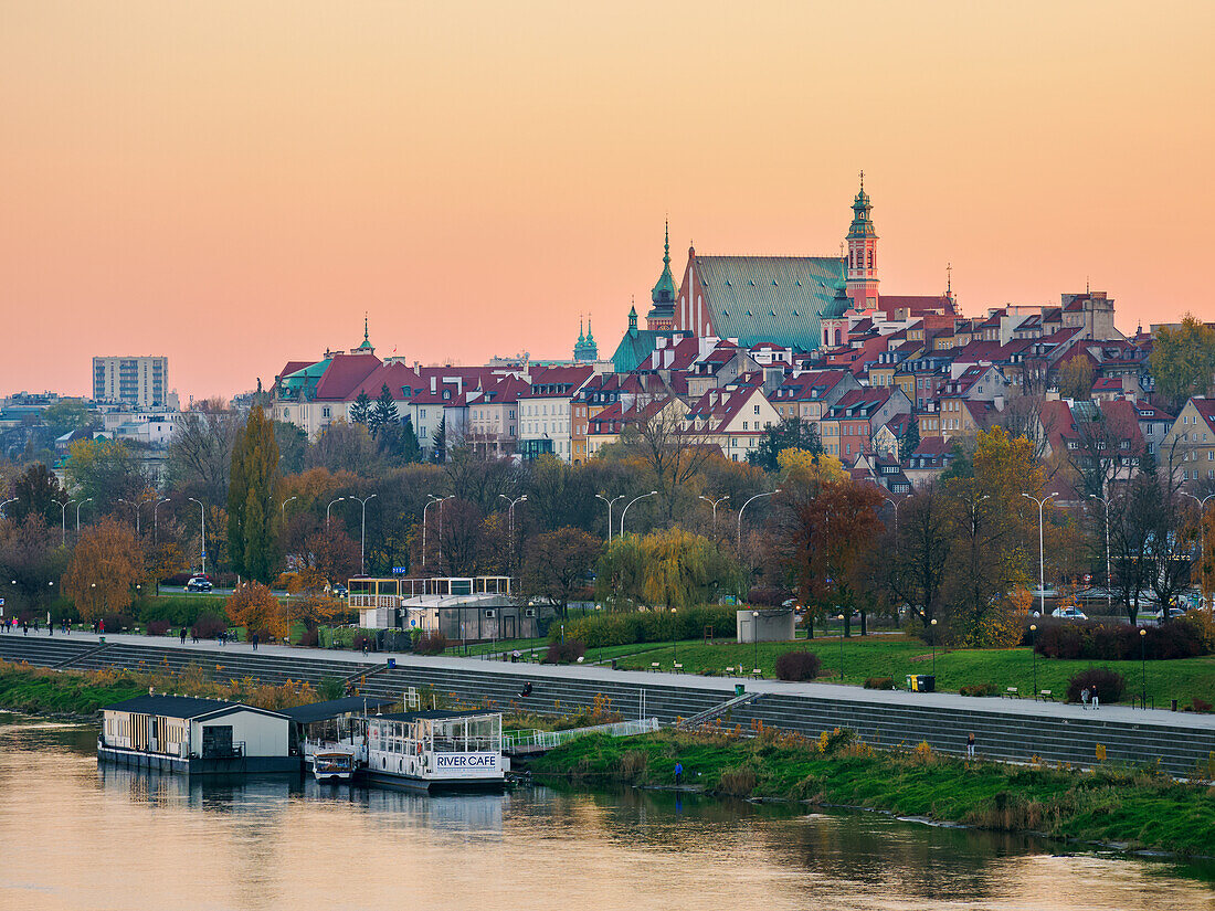 View over River Vistula towards The Old Town at sunset, Warsaw, Masovian Voivodeship, Poland, Europe
