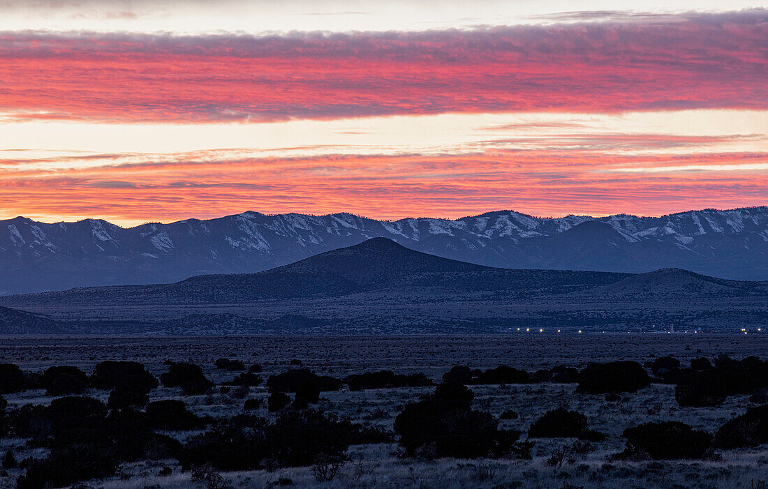 USA, New Mexico, Santa Fe, Dramatic sunset sky over Cerrillos Hills State Park desert landscape