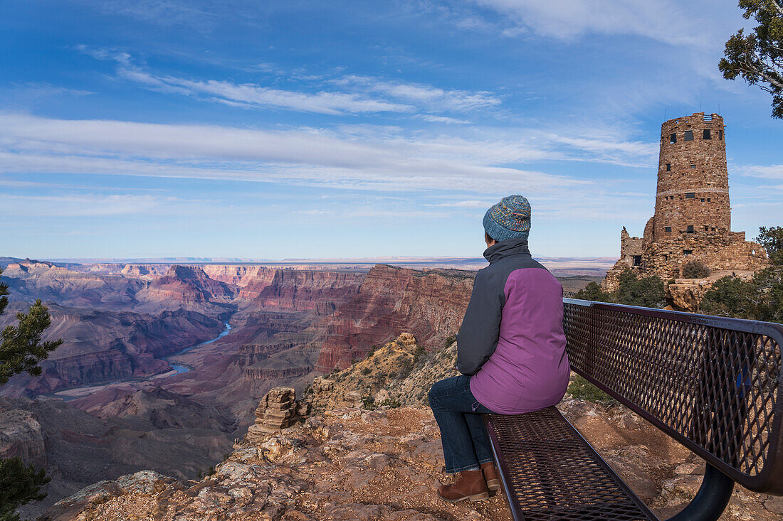 USA, Arizona, Rear view of female tourist sitting on bench in Grand Canyon National Park